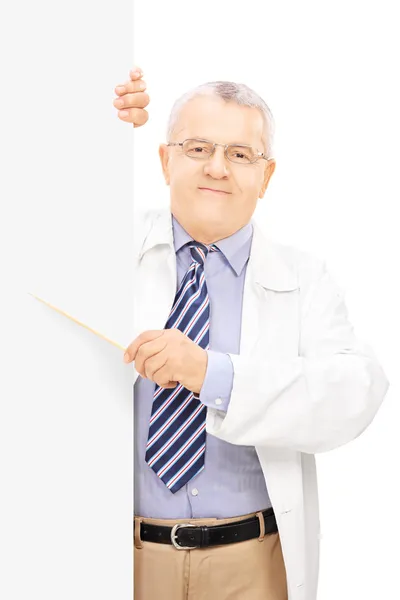 Doctor pointing to blank panel — Stock Photo, Image