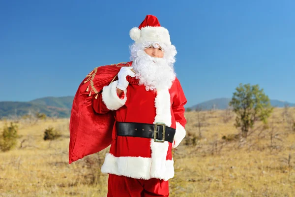 Santa Claus sosteniendo bolsa de regalos — Foto de Stock