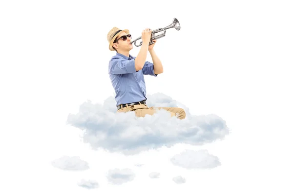 Musician playing a trumpet on clouds — Stock Photo, Image