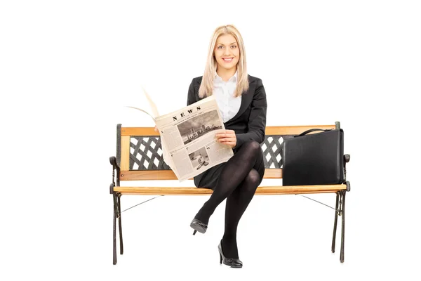 Imprenditrice su una panchina che tiene un giornale — Foto Stock