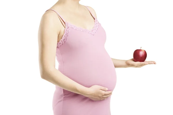 Donna incinta con una mela in mano — Foto Stock