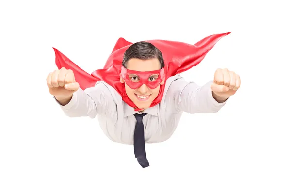 Superhero with red cape flying — Stock Photo, Image