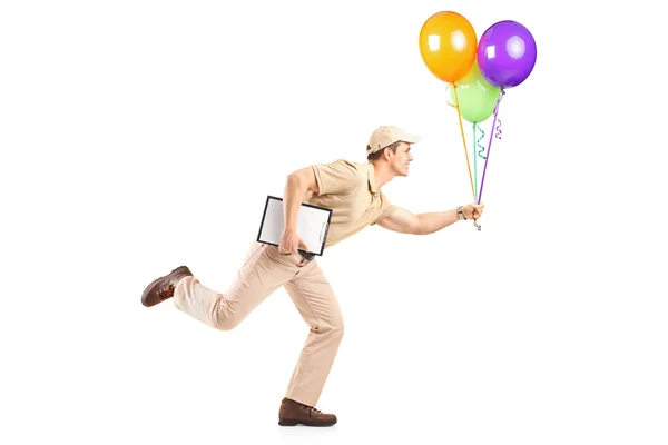 Delivery boy delivering balloons — Stock Photo, Image