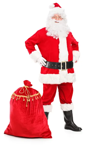 Papai Noel posando ao lado do saco — Fotografia de Stock