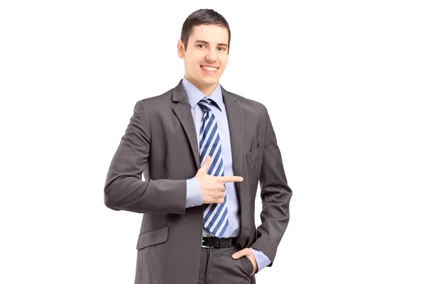 Young businessman standing and pointing — Stock Photo, Image