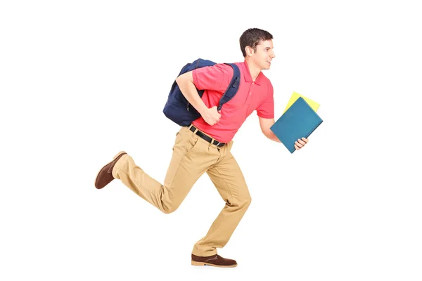 Student holding books and running — Stock Photo, Image