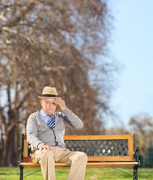 Homme âgé dans le parc ayant mal à la tête — Photo