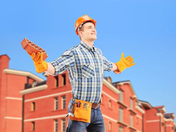 Worker holding brick — Stock Photo, Image