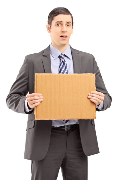 Upset businessman holding cardboard — Stock Photo, Image