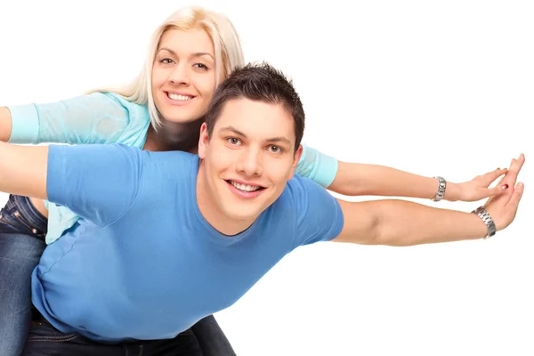 Happy couple posing piggyback — Stock Photo, Image