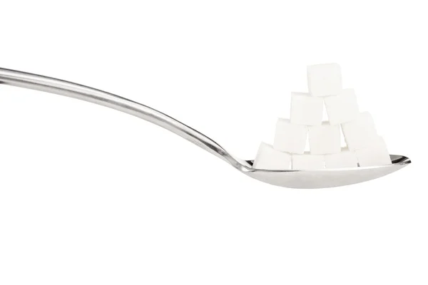 Sugar cubes on a metal spoon — Stock Photo, Image