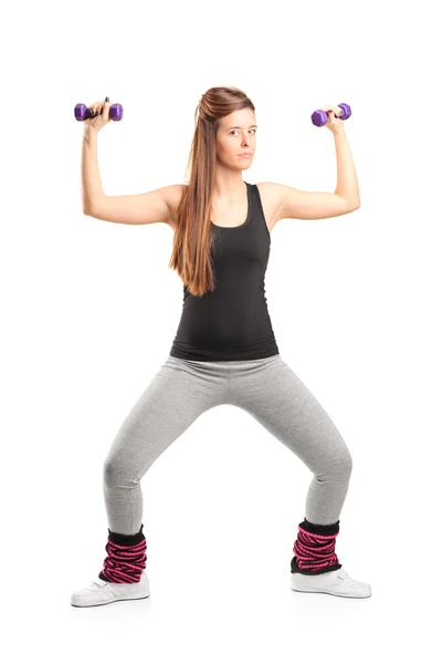 Young girl exercising with dumbbells — Stock Photo, Image