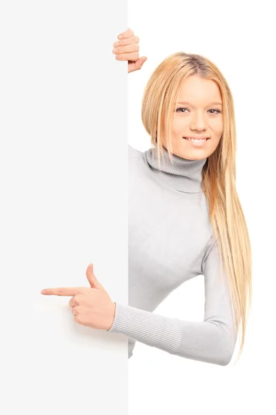 A beautiful blond female pointing on a panel — Stock Photo, Image