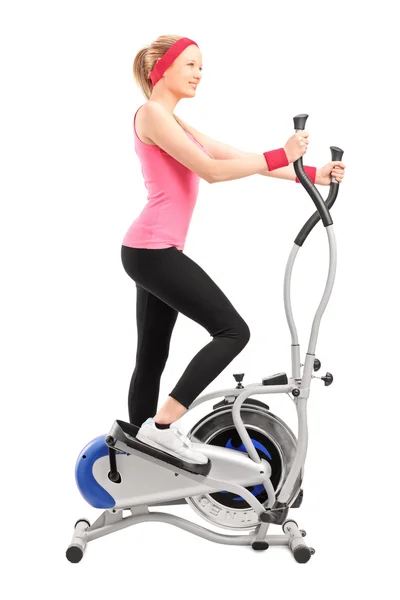 Athlete on cross trainer machine — Stock Photo, Image