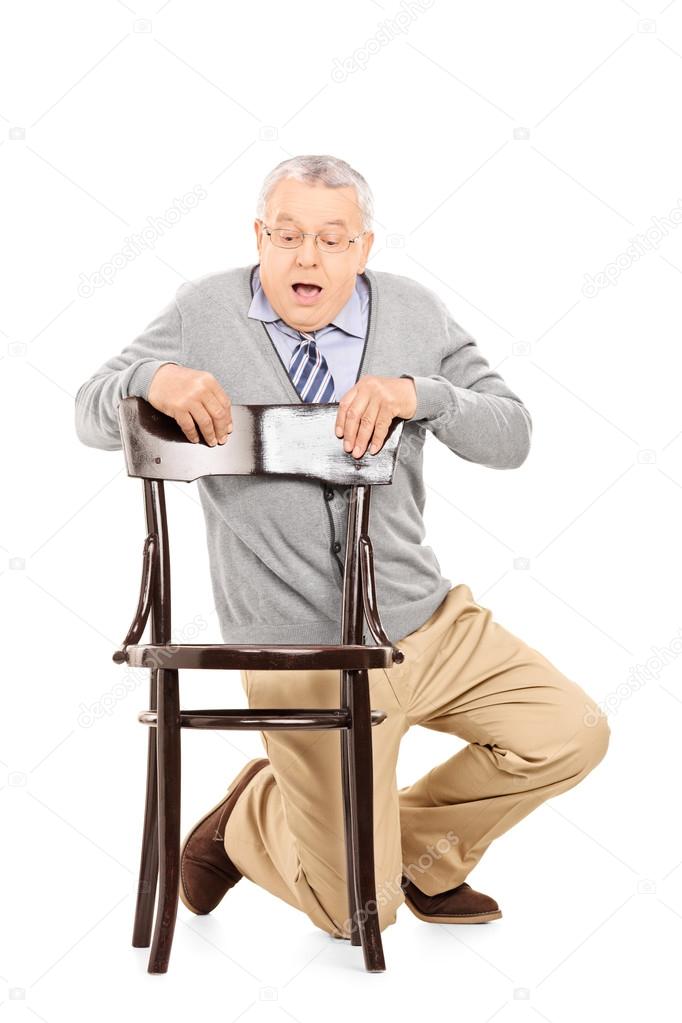 Scared gentleman hiding behind chair — Stock Photo © ljsphotography