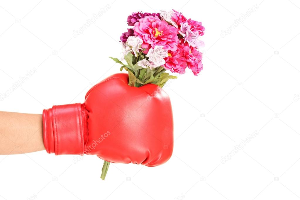 Hand in boxing glove holdin flowers