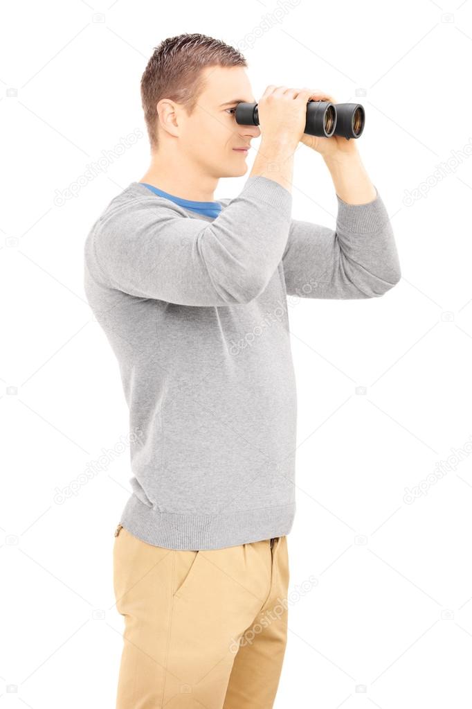 Casual man looking through binocular