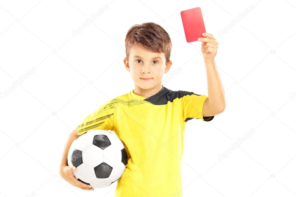 Kid holding soccer ball and red card