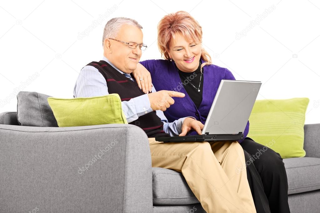 Mature couple looking at laptop