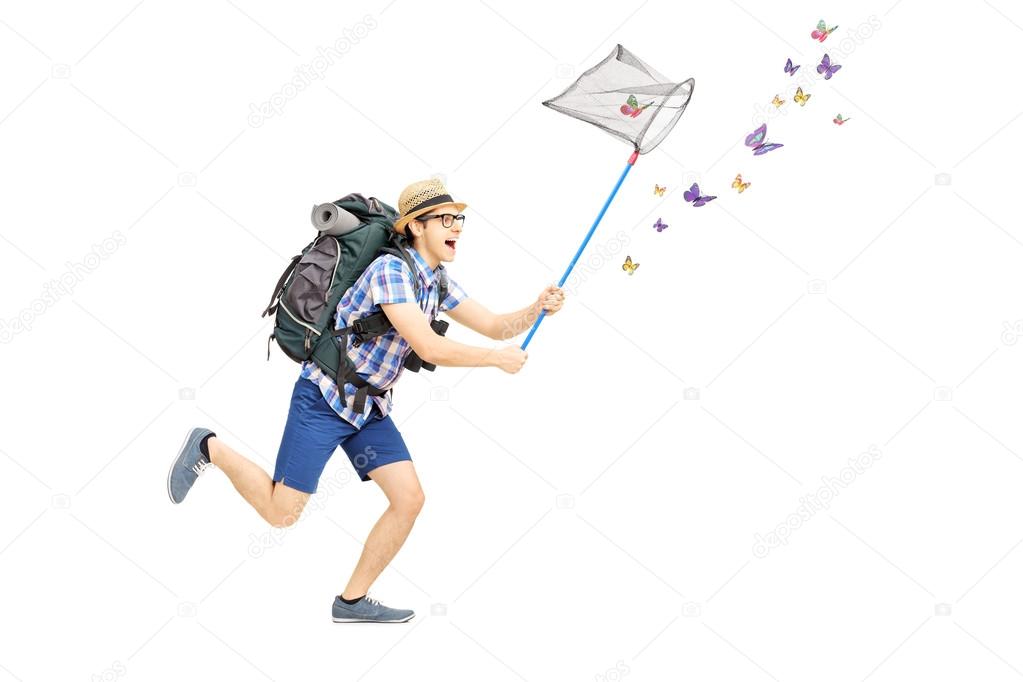 Male tourist catching butterflies with net