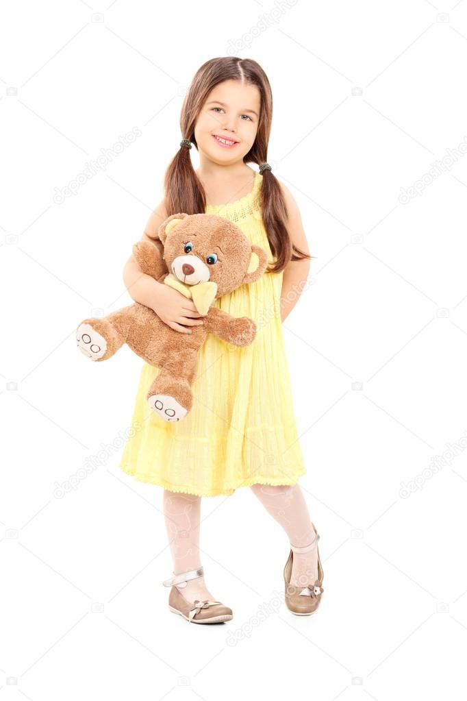 little girl holding a teddy bear