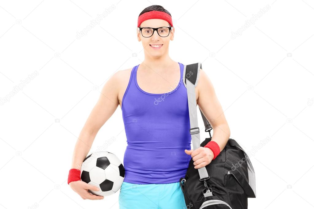 Athlete with sports bag holding football