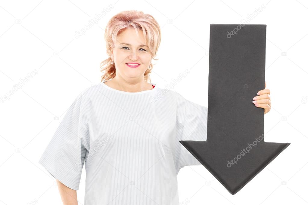 Female patient holding black arrow