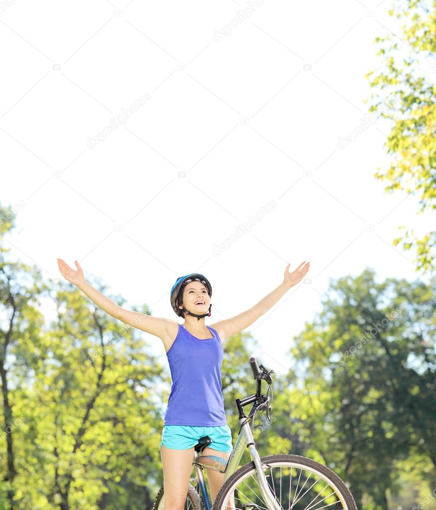 Female biker with raised hands