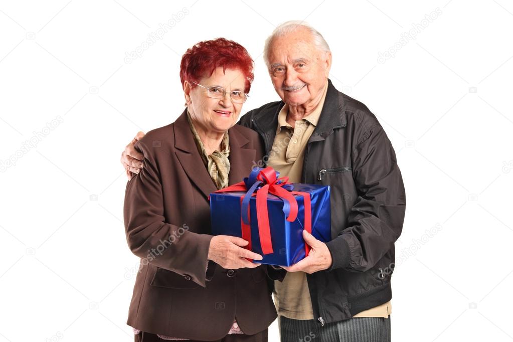 Senior couple holding gift