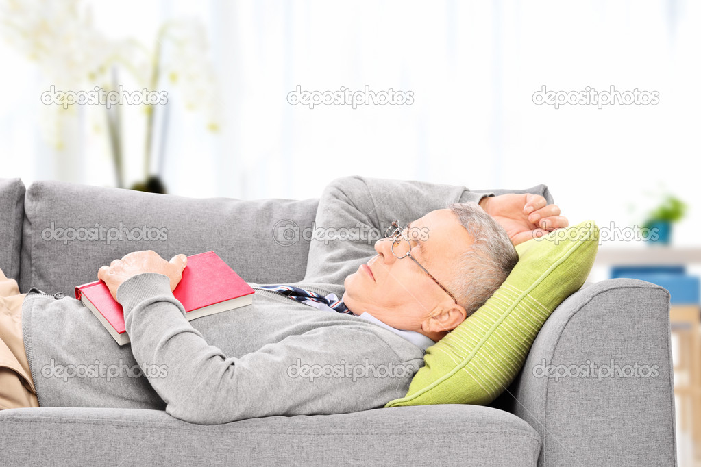 Senior man sleeping on sofa 