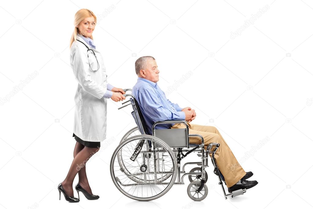 Doctor pushing man in wheelchair
