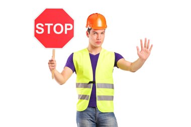 A construction worker holding a traffic sign stop
