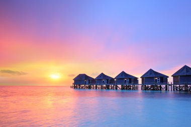Sunset on Maldives island clipart
