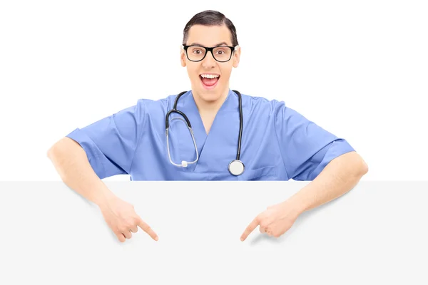 Doctor pointing on blank panel — Stock Photo, Image