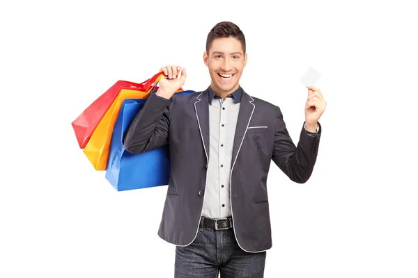 Cara segurando sacos de compras — Fotografia de Stock