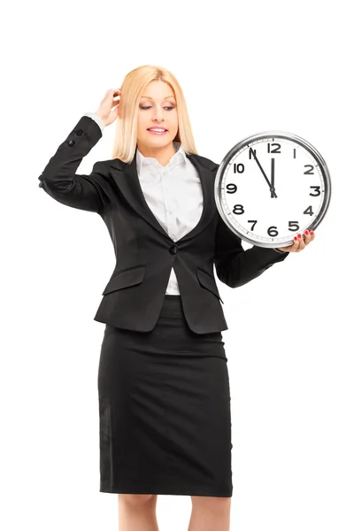 Businesswoman holding wall clock — Stock Photo, Image