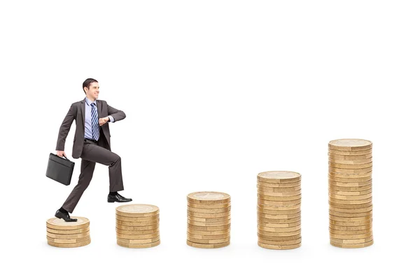 Ambitious businessman walking over piles — Stock Photo, Image