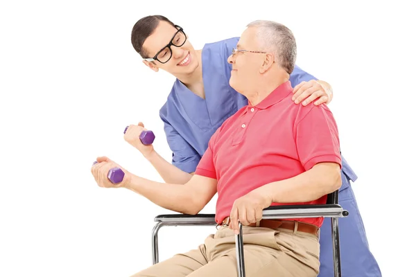 Physiotherapist showing an exercise to a mature man — Stock Photo, Image