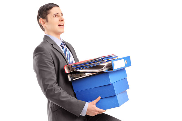 Professional man carrying heavy folders