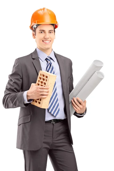 Male engineer holding brick — Stock Photo, Image