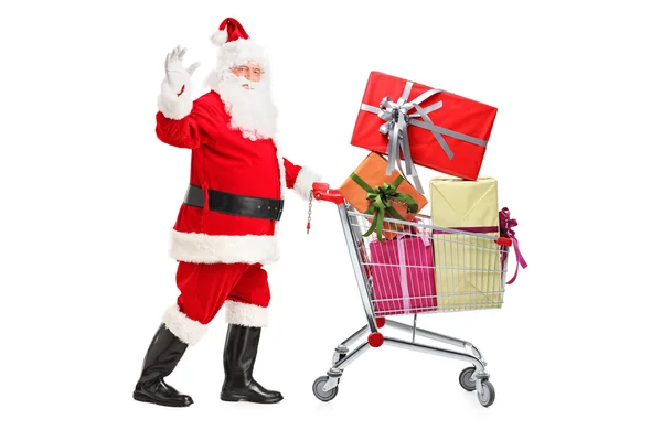 Babbo Natale spingendo carrello pieno di regali — Foto Stock