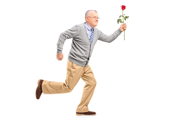 Gentleman running with red rose — Stock Photo, Image