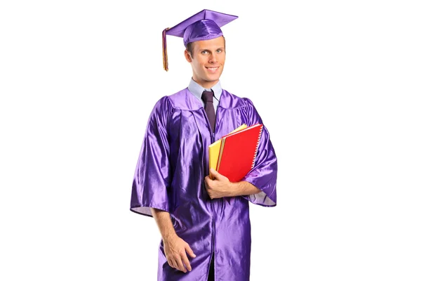 Estudiante graduado sosteniendo libros — Foto de Stock