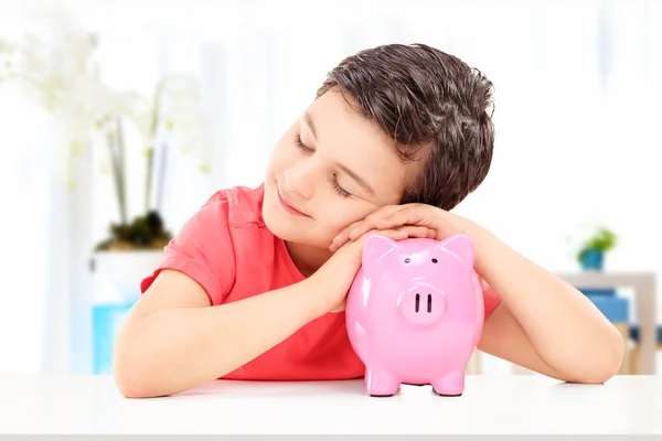 Niño durmiendo en Piggybank — Foto de Stock