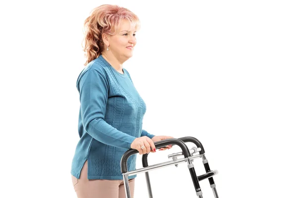 Mature woman walking with walker — Stock Photo, Image