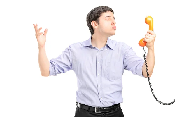 Cara segurando tubo de telefone — Fotografia de Stock