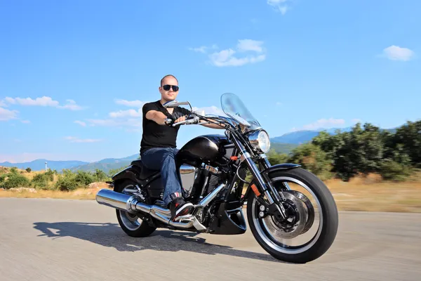 Biker riding customized motorcycle — Stock Photo, Image