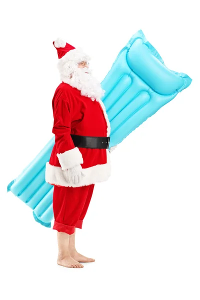 Santa Claus sosteniendo colchón de natación —  Fotos de Stock