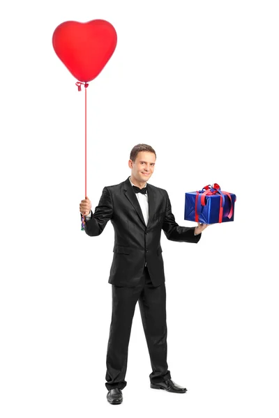 Man holding balloon and gift — Stock Photo, Image