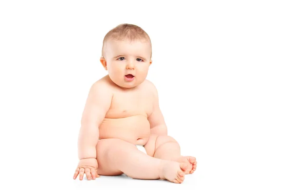 A 9 months old baby in diapers sitting — Stock Photo, Image